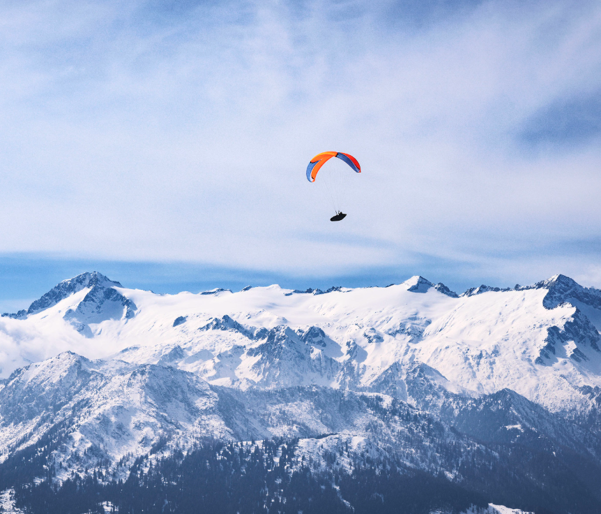 Parapendio tra le montagne innevate